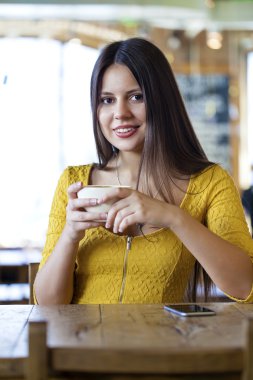 Oturan bir kahvehane ve çay içmek güzel genç kadın