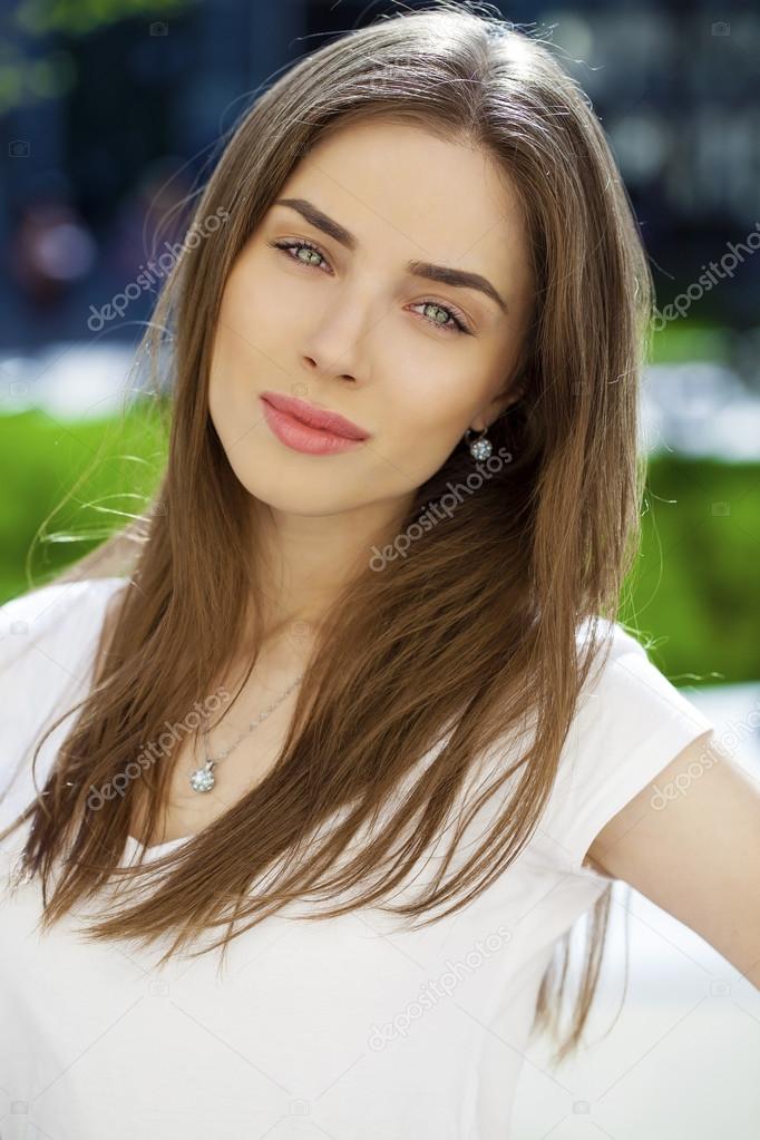 Portrait of young woman on summer street 