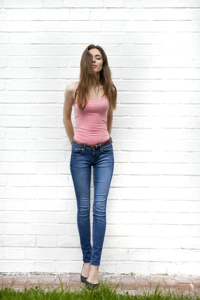 Portrait of a beautiful woman in blue jeans — Stok Foto