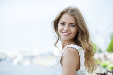 Poz açık havada içinde güneşli biz yeşil elbiseli genç güzel kadın