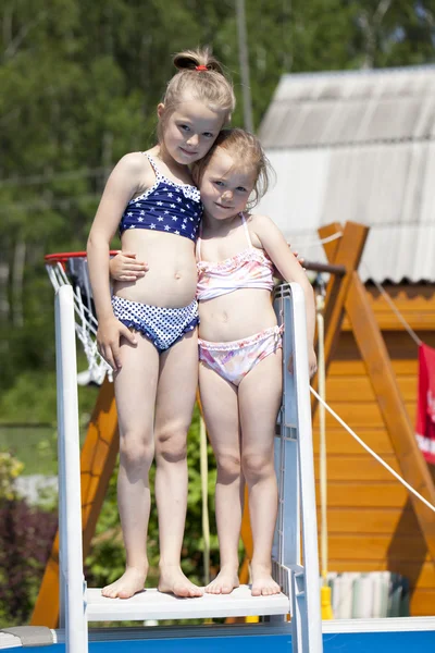 Two sisters in bikini near swimming pool. Hot Summer — Stock Photo, Image