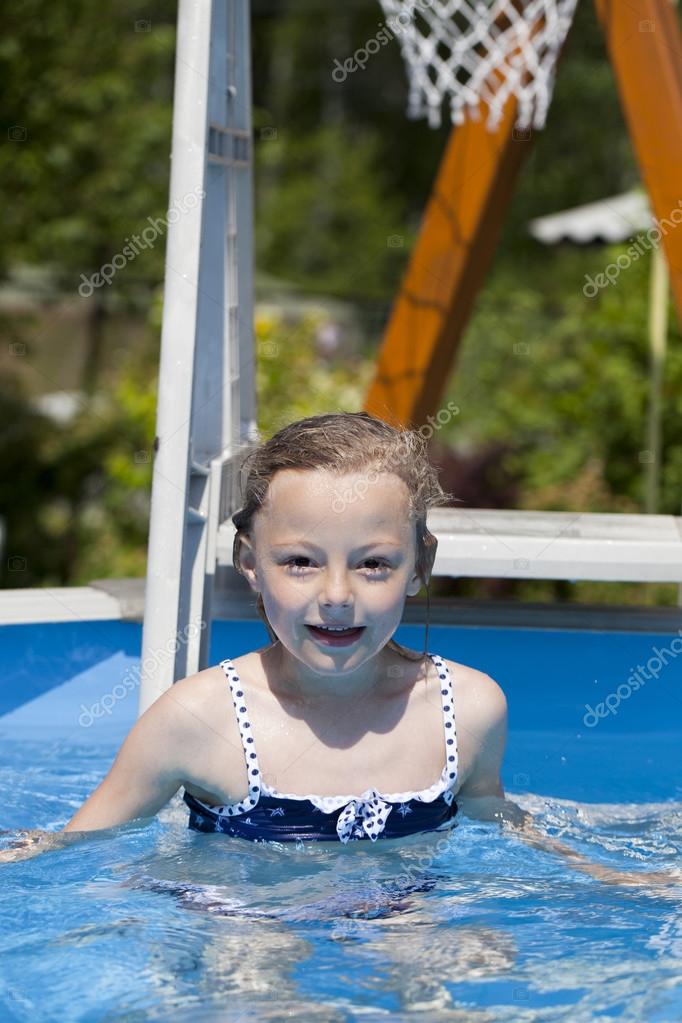 Child girl in blue bikini near swimming pool. Hot Summer — Stock Photo