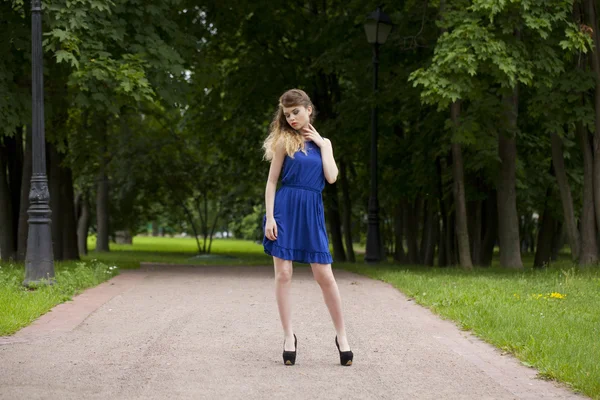 Beautiful young blonde woman in blue dress — Stock Photo, Image