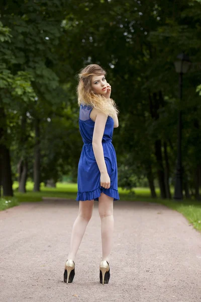 Beautiful young blonde woman in blue dress — Stock Photo, Image