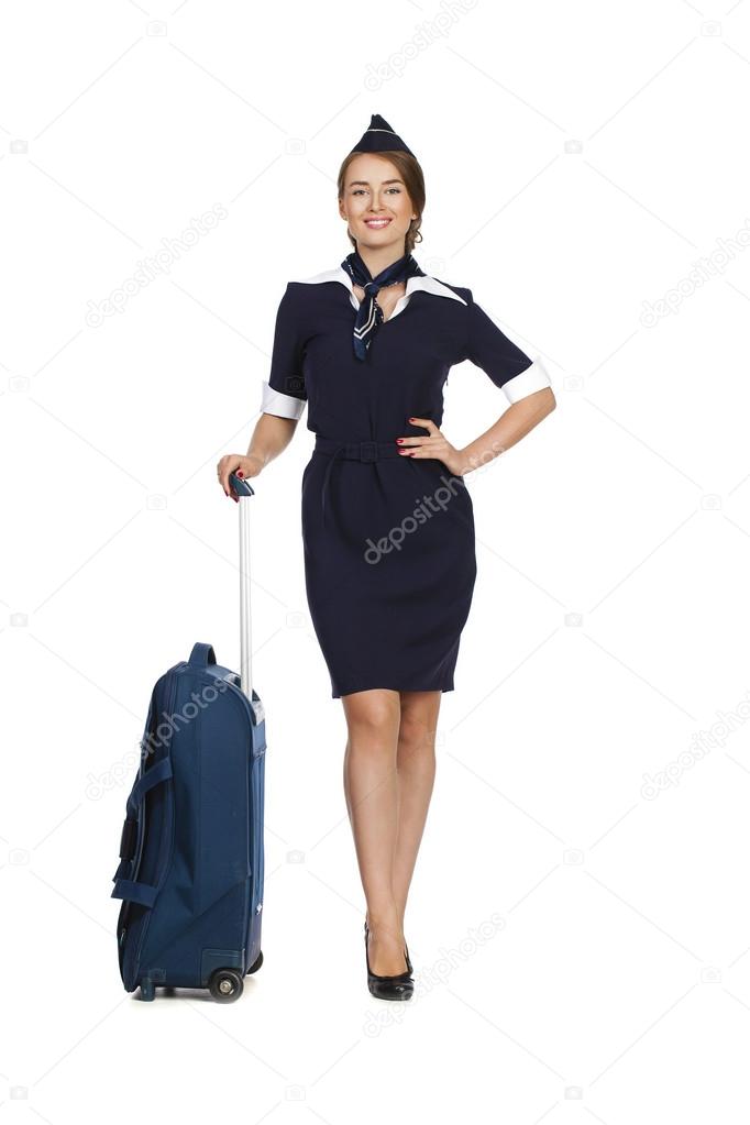 Beautiful stewardess holding suitcase isolated on white backgrou