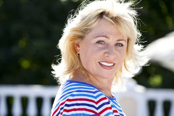 Portrait of serene mature woman in the summer park — Stock Photo, Image