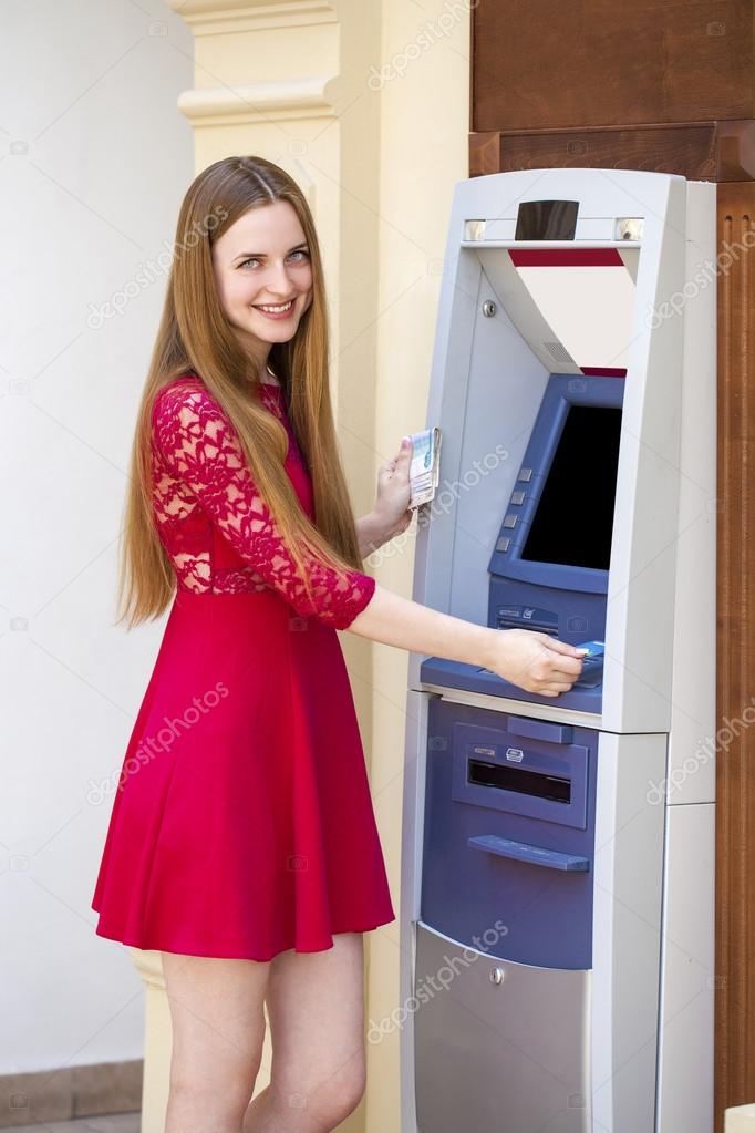 Blonde lady using an automated teller machine 