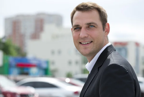 Portrait of a young business man in a dark suit and white shirt — Stock Photo, Image