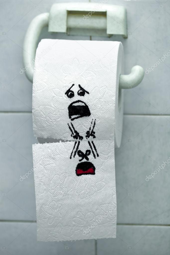 Roll of toilet paper and felt tip pen drawn funny faces