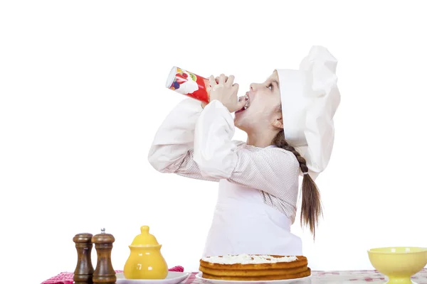 Cooking and people concept - smiling little girl in cook hat — Stock Photo, Image