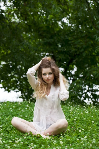 Young blonde woman on green meadow — Stock Photo, Image