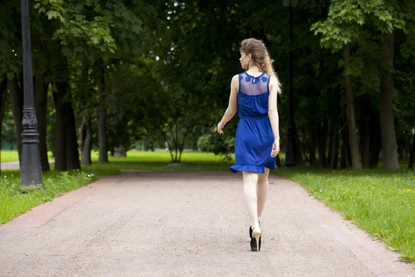 Beautiful young blonde woman in blue dress — Stock Photo, Image