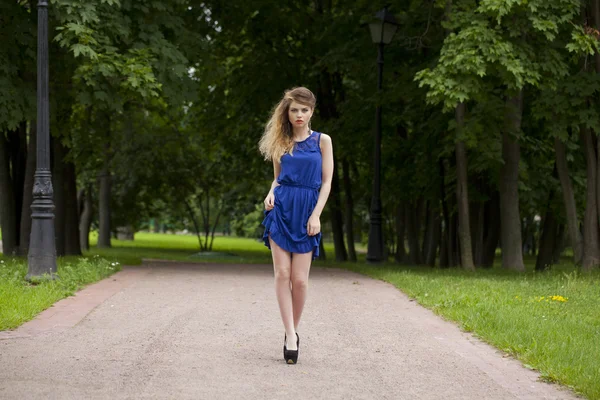 Beautiful young blonde woman in blue dress — Stock Photo, Image