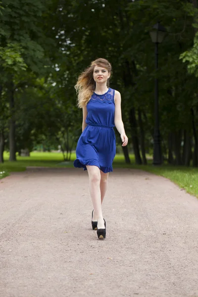 Beautiful young blonde woman in blue dress — Stock Photo, Image