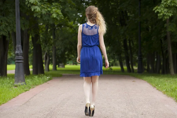 Beautiful young blonde woman in blue dress — Stock Photo, Image