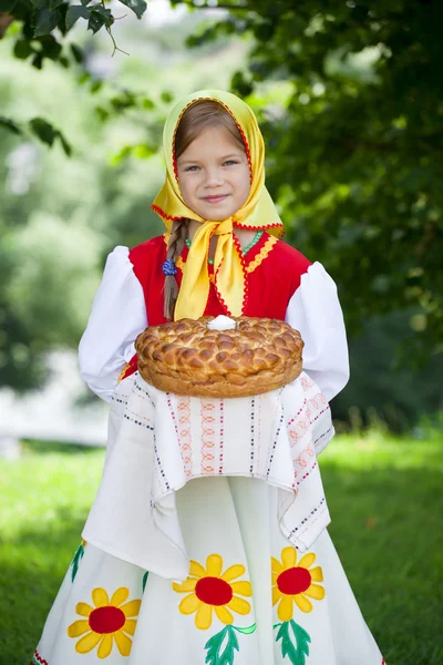 Little girl is dressed in the Russian national dress in summer p — Stock Photo, Image