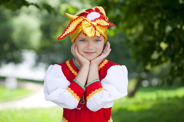 Little girl is dressed in the Russian national dress in summer p — Stock Photo, Image