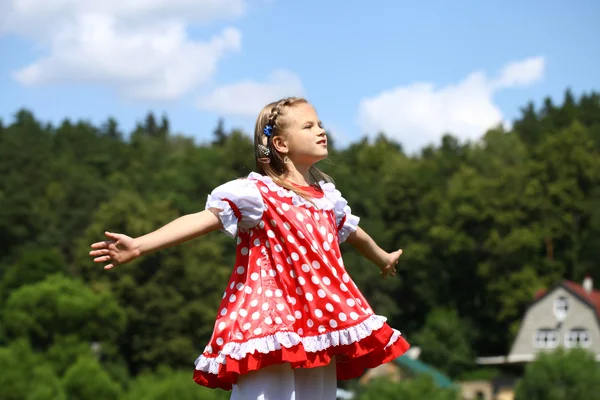 Little girl in a red polka-dot sundress into a major run on the — Stock Photo, Image