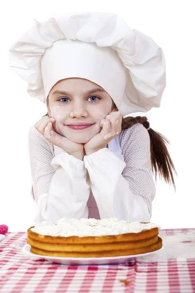 Kochen und Menschen-Konzept - lächelndes kleines Mädchen mit Kochmütze — Stockfoto