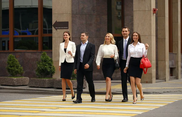 Команда из пяти бизнесменов уверенно шагает по сумме — стоковое фото
