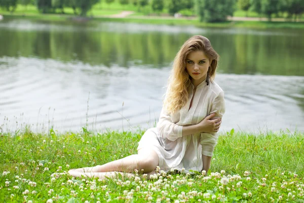 Jeune femme blonde sur prairie verte — Photo