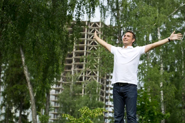 Happy Young handsome man on the background of summer street — Stock Fotó