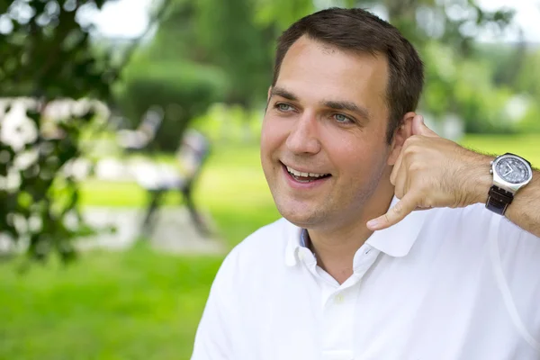 Happy brunette men making a call me gesture — Stockfoto