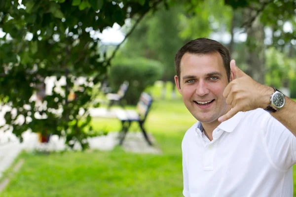 Happy brunette men making a call me gesture — Stok fotoğraf