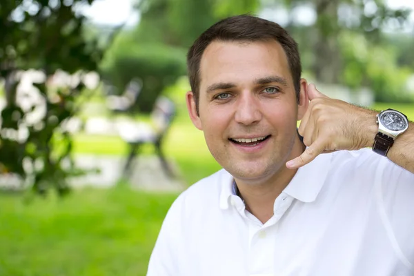 Happy brunette men making a call me gesture — Stockfoto