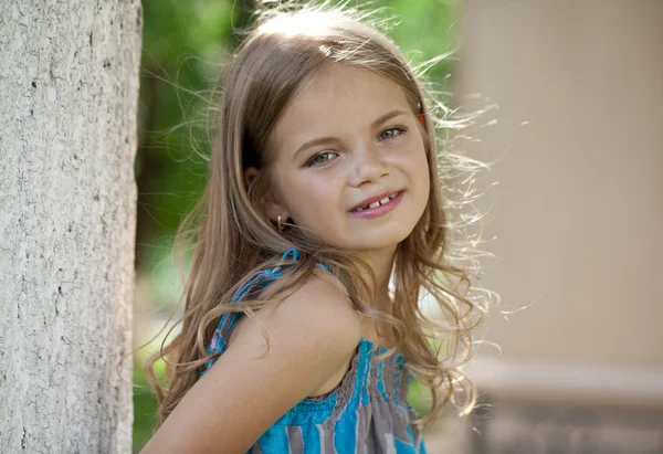 Close up portrait of a seven year little girl, against backgroun — Stock Photo, Image