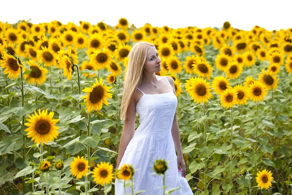 Portrait of a beautiful young blonde woman in a white dress on a — Stock Photo, Image