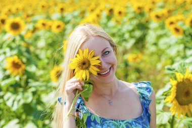Güzel bir sarışın genç kadın bir ba üzerinde mavi elbiseli portresi