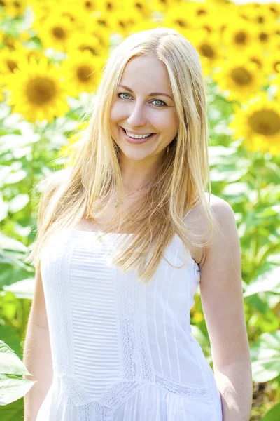 Portrait of a beautiful young blonde woman in a white dress on a Stock Picture