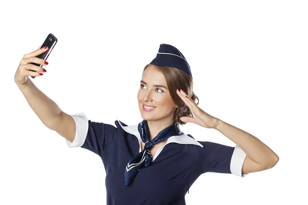 Gelukkig jonge stewardess houden een slimme telefoon geïsoleerd op witte b — Stockfoto