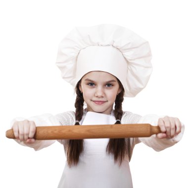 Cute little girl baking on kitchen and shows rolling-pin