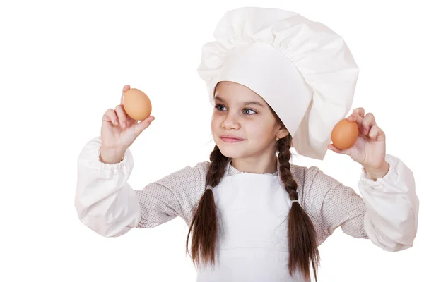 Portrait of a little girl in a white apron holding two chicken e — Stock Photo, Image