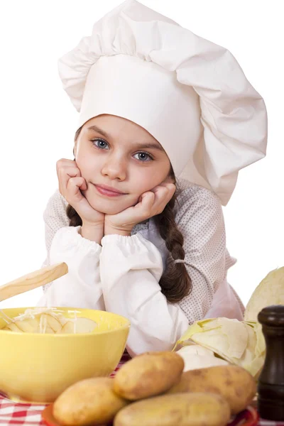 Beautiful little chief cooker on the desk with vegetables — Stock Photo, Image