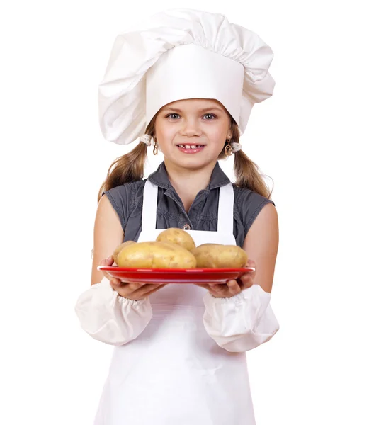 烹饪和人们的观念-微笑在厨师的帽子的小女孩 — 图库照片