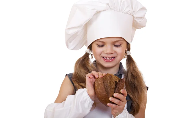 Cocina y concepto de la gente - niña sonriente en sombrero de cocinero — Foto de Stock