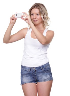 Happy Girl posing for a photograph taken from his cell phone  clipart