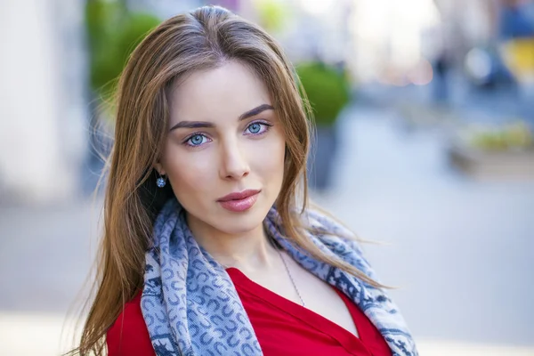 Portrait of a beautiful young girl in red shirt on the backgroun — Stock Photo, Image