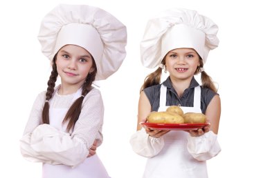 Yemek ve insanlar kavramı - iki küçük kız beyaz bir önlük 