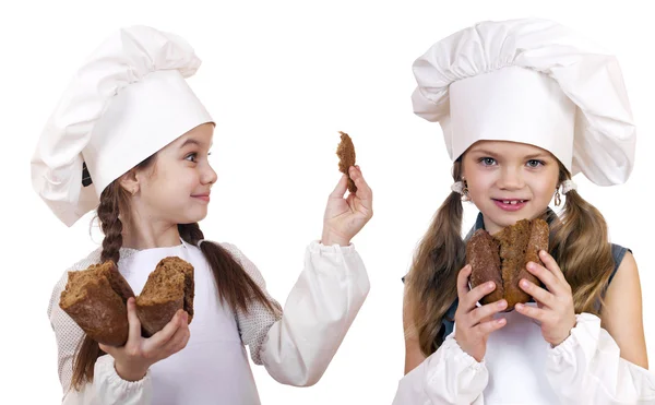 Cooking and people concept - Two little girls in cook hat — Stock Photo, Image