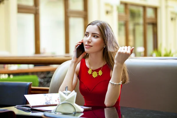 Beautiful brunette girl sitting in a coffee shop — Stock Photo, Image