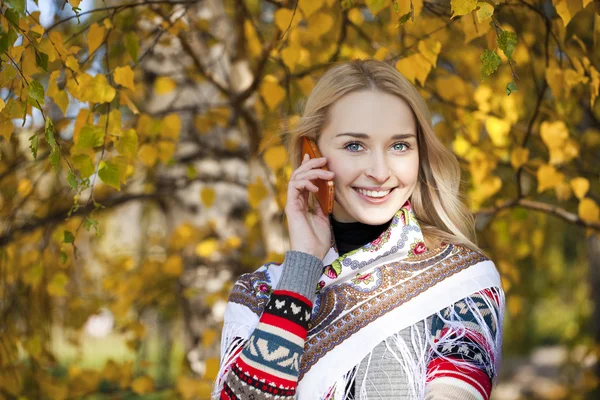 Porträtt av en vacker ung kvinna ringer via telefon — Stockfoto