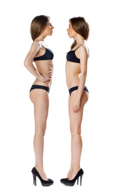 Portrait in full growth, two beautiful models in black lingerie,