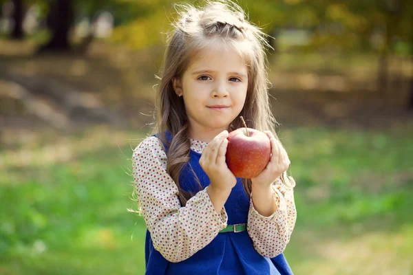 Portrait of a little girl with red large apple — Stock Photo, Image