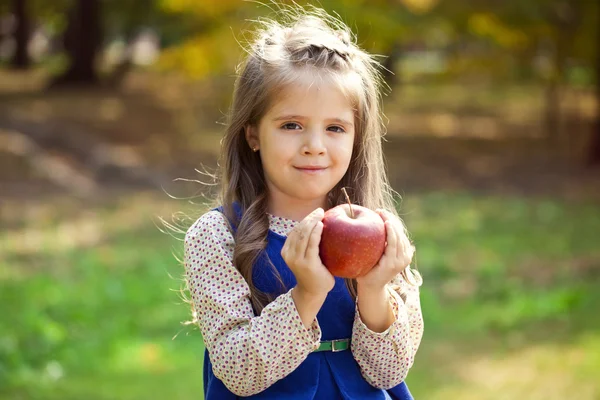 Portrait of a little girl with red large apple — Stock Photo, Image