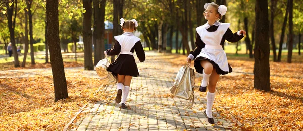 Happy little schoolgirl go home from school — Stock Photo, Image