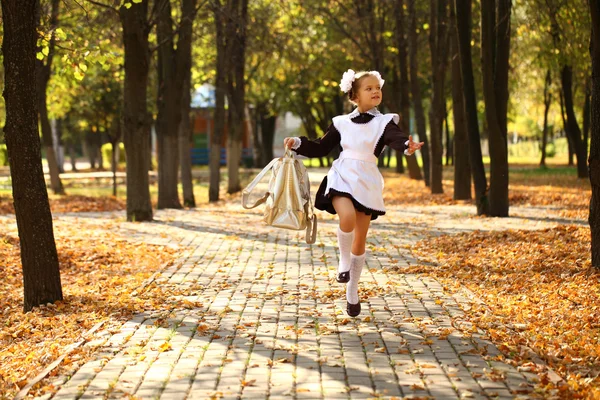 Happy little schoolgirl go home from school — Stock Photo, Image